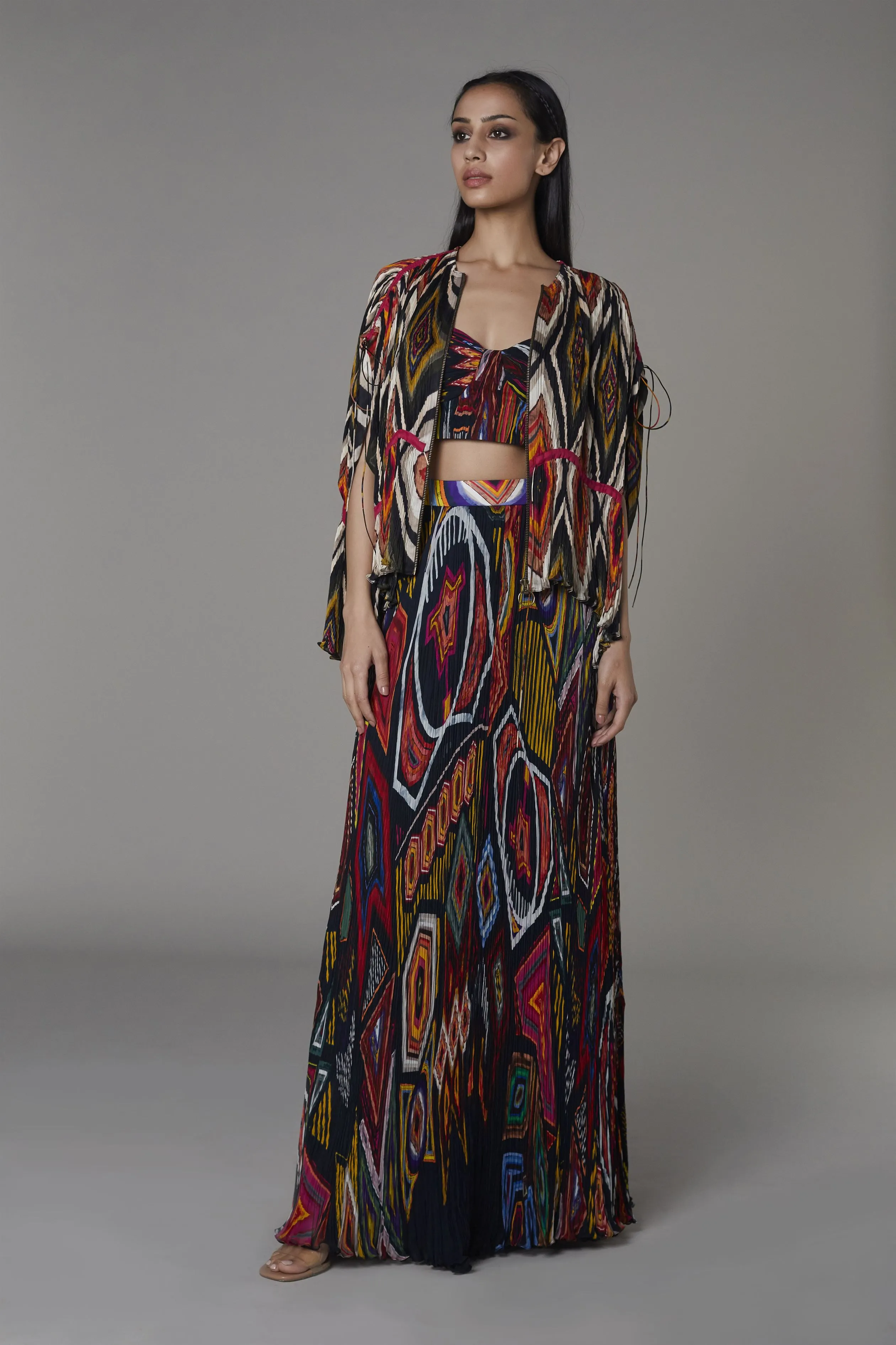 Saaksha & KinniÂ    I   Afghani print cape

Navy blue mix booti bustier

Navy blue mix booti pleated skirt"

 Cape - Chiffon / Organza

Bustier - Chiffon

Skirt - Chiffon Multi SS22098

  SS22113

  SS22114